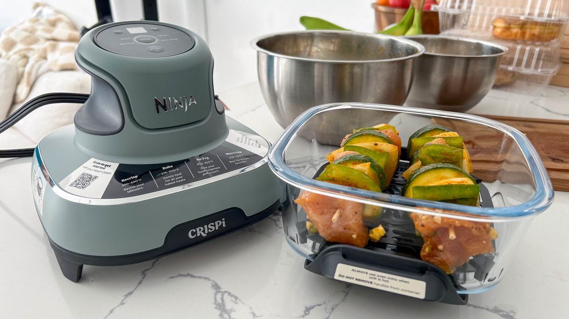 ninja crispi portable air fryer cooking couple of chicken kebob in it