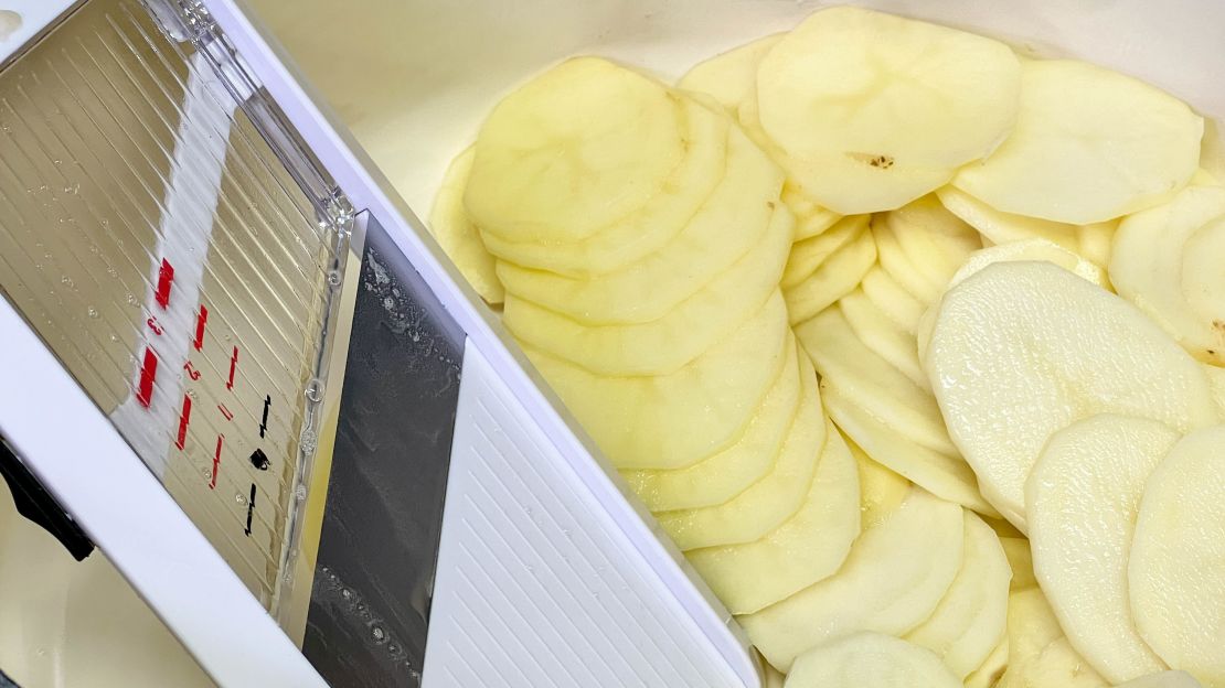 OXO good grips mandoline next to the potatoes sliced with it